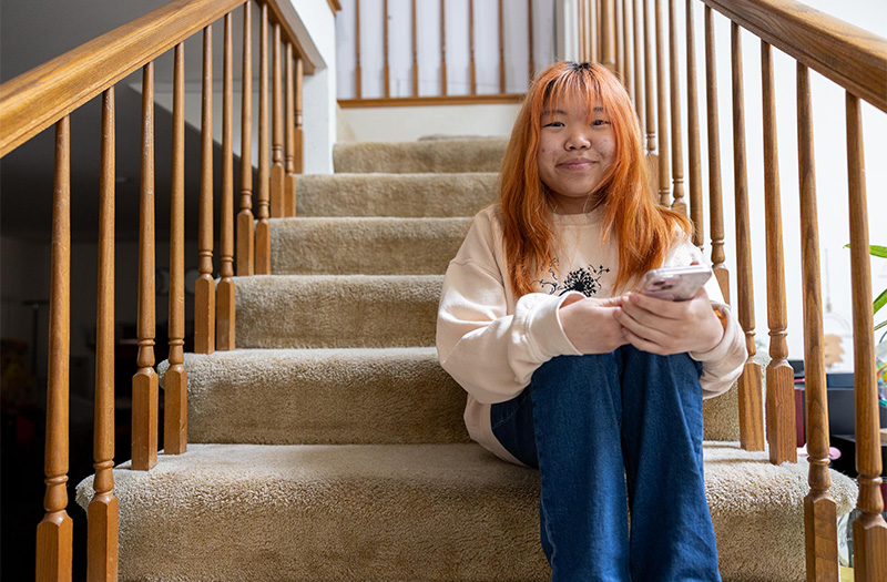 BioMarin patient sitting on her stairs.