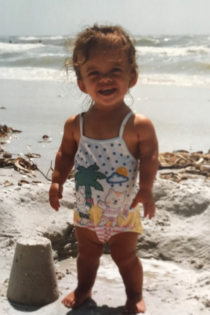 Kristen DeAndrade as a child at the beach.