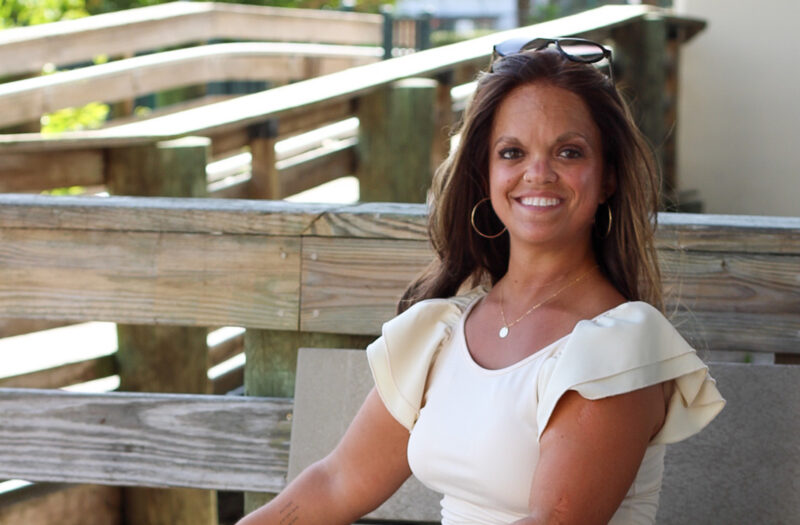 Kristen DeAndrade, sitting outside.