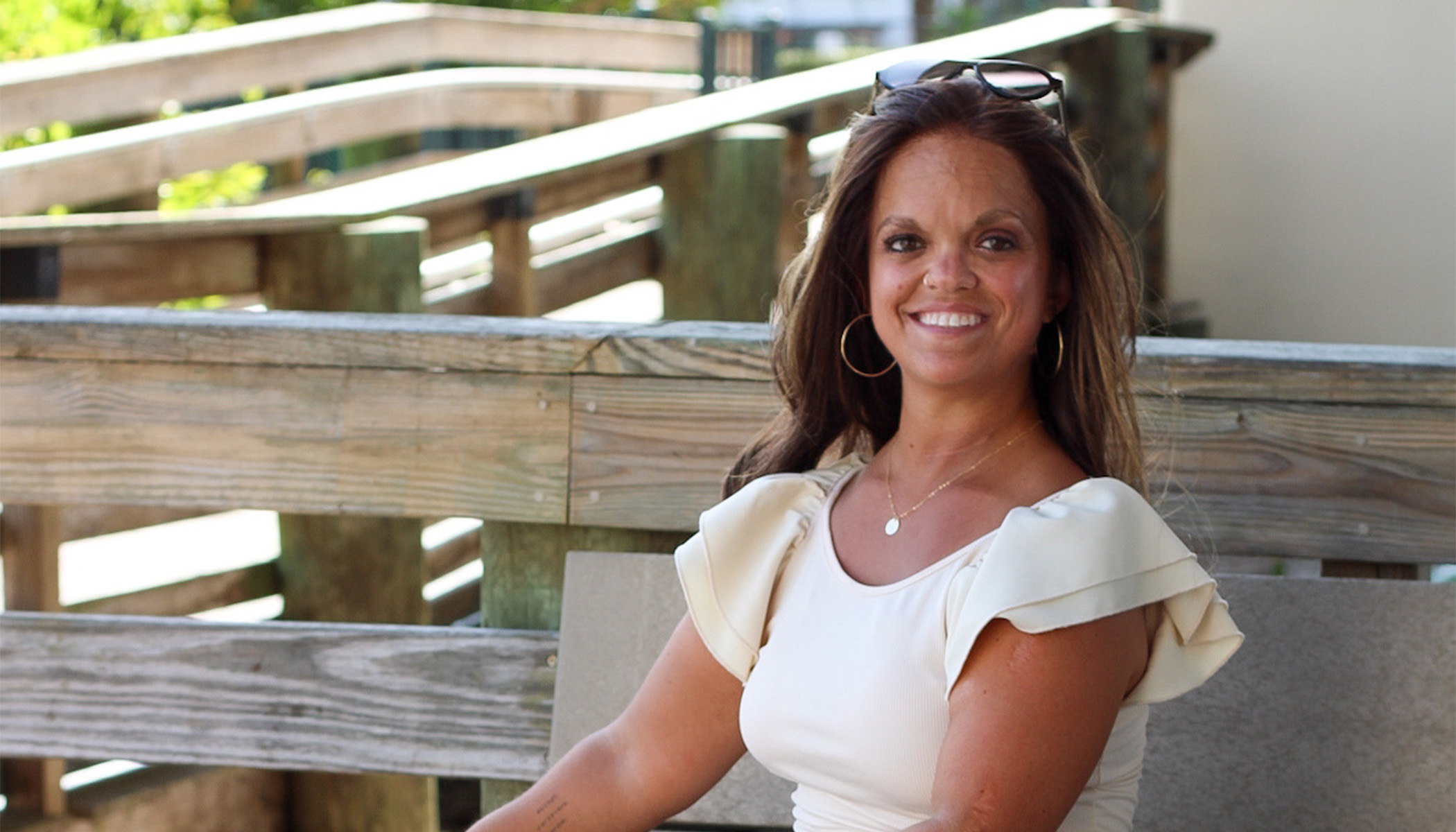 Kristen DeAndrade, sitting outside.